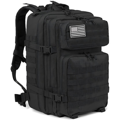 A black tactical backpack with multiple zippered compartments, MOLLE webbing, and a black-and-white American flag patch on the front pocket, shown on a plain white background.